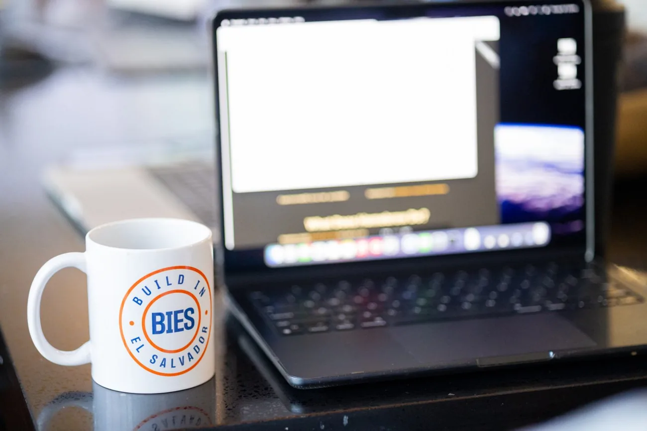 A laptop with a BIES mug